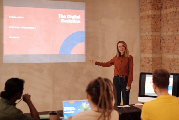 A woman in red dress gives a business coaching lesson